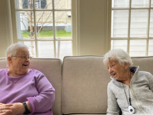 elderly friends laughing together